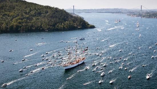 Picture shows Statsraad Lehmkuhl with boat-cortege from Sotra bridge